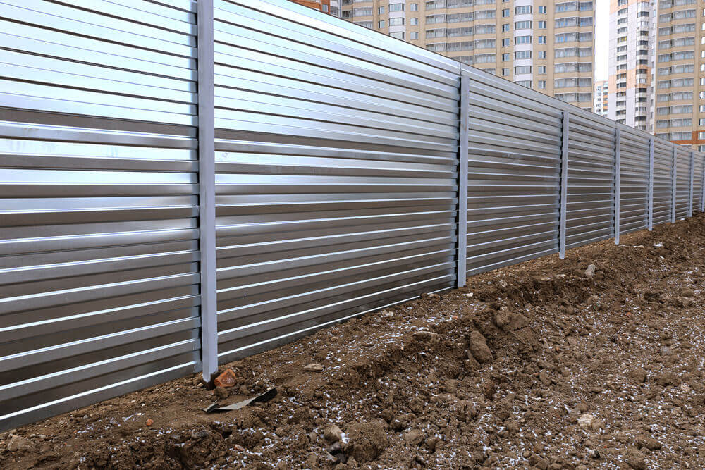 steel fence in a construction site made by fencing Toowoomba with several high rise buildings in the background