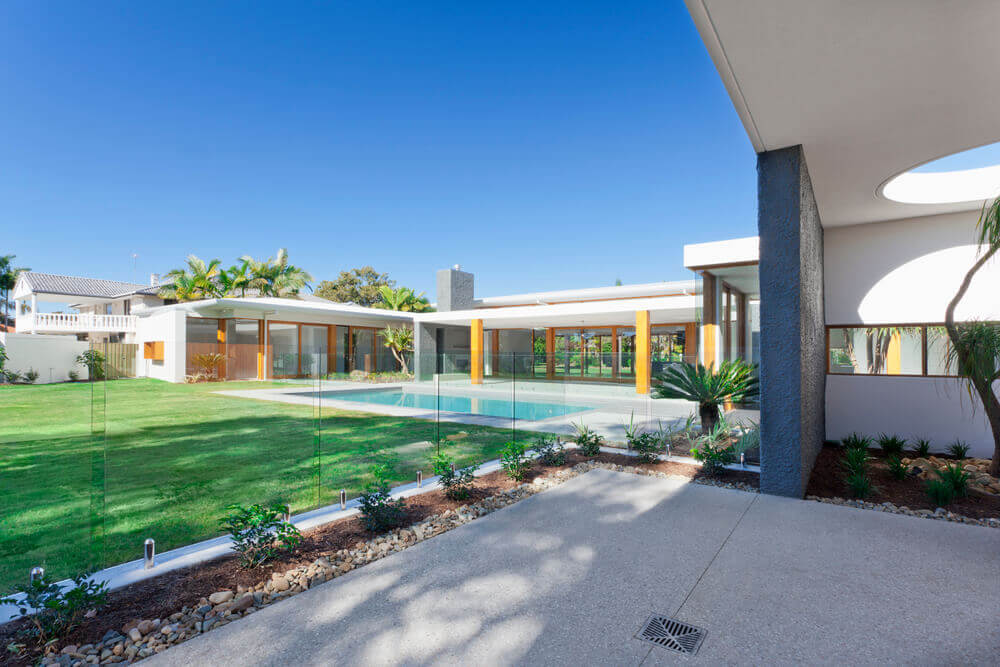 huge luxury backyard with a pool featuring a classy glass pool fence built by pool fencing Toowoomba